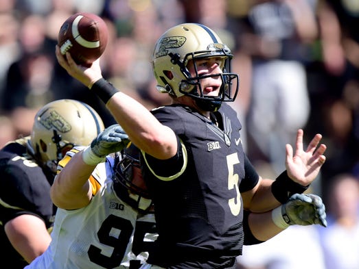 Sep 27, 2014; West Lafayette, IN, USA; Purdue Boilermakers quarterback Danny Etling (5) throws the football before being tackled by Iowa Hawkeyes defensive lineman Drew Ott (95) in the second half of the game at Ross Ade Stadium against the Iowa Hawkeyes. The Iowa Hawkeyes beat the Purdue Boilermakers 24 to 10. Mandatory Credit: Marc Lebryk-USA TODAY Sports