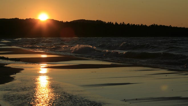 The sun sets on a beach in the Sleeping Bear Dunes National Lakeshore Park.