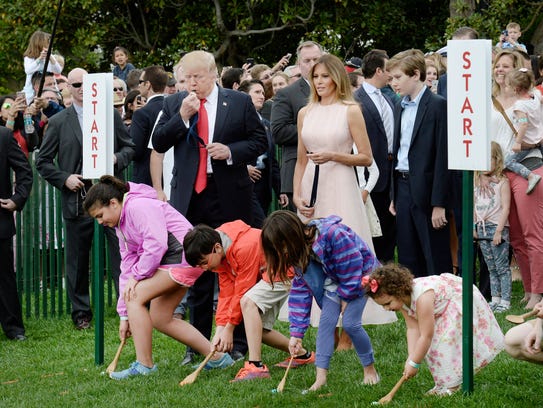 President Trump blows a whistle to start the egg roll.