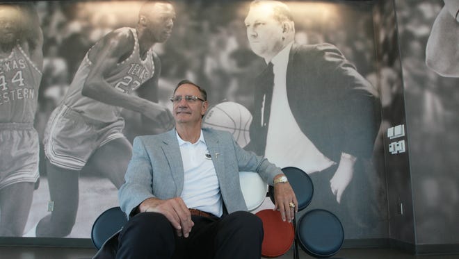 In this 2013 photo, UTEP Athletic Director Bob Stull poses at the Foster Stevens Basketball Complex in front of a mural of the late head basketball coach Don Haskins and the 1966 Texas Western College team.