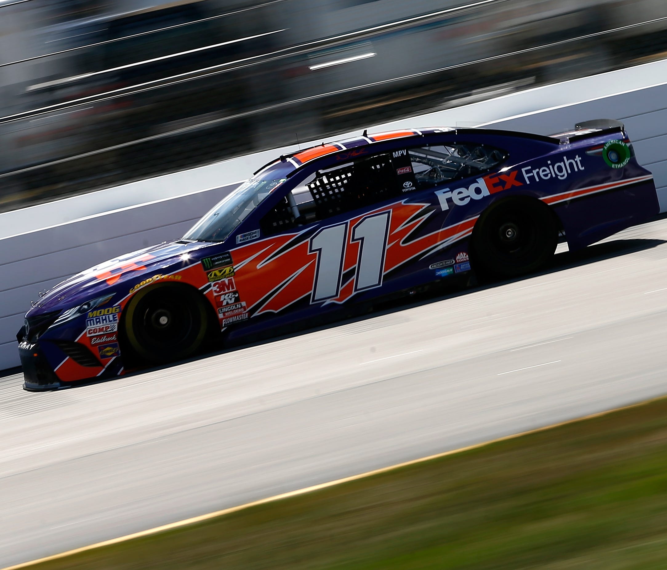 Denny Hamlin, practicing at New Hampshire, would like to see the sticky compound used at other tracks.