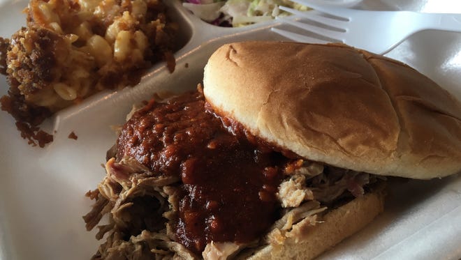 A pulled-pork sandwich, macaroni and cheese and coleslaw from Currie's Smokin Hot BBQ.