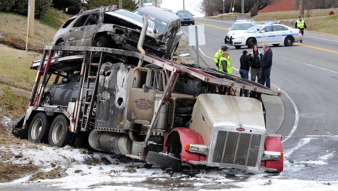 Metro police investigate a tractor-trailer crash at the corner of Spence Lane and Murfreesboro Road Friday Feb. 13, 2015, in Nashville, Tenn.