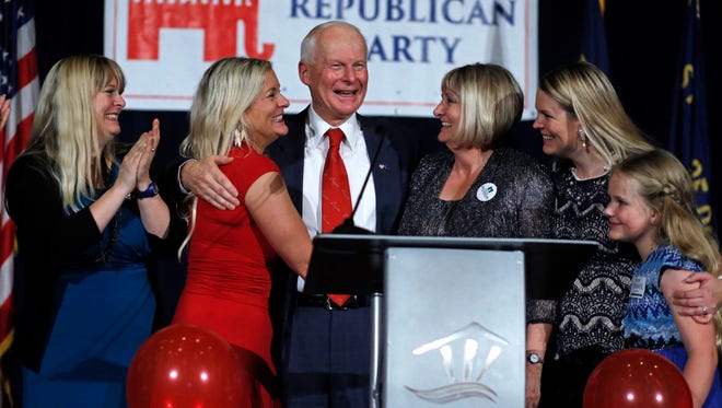 Dennis Richardson, center, Oregon Republican Secretary of State candidate, is surrounded by his family, daughters Valerie Harmon, left, Jennifer Vranes, second from left, his wife Cathy, third from right, daughter Rachel Whoolery, second from right, and granddaugher Samara Whoolery, right, at an election night event at the Salem Convention Center in Salem, Ore., Tuesday Nov. 8, 2016.