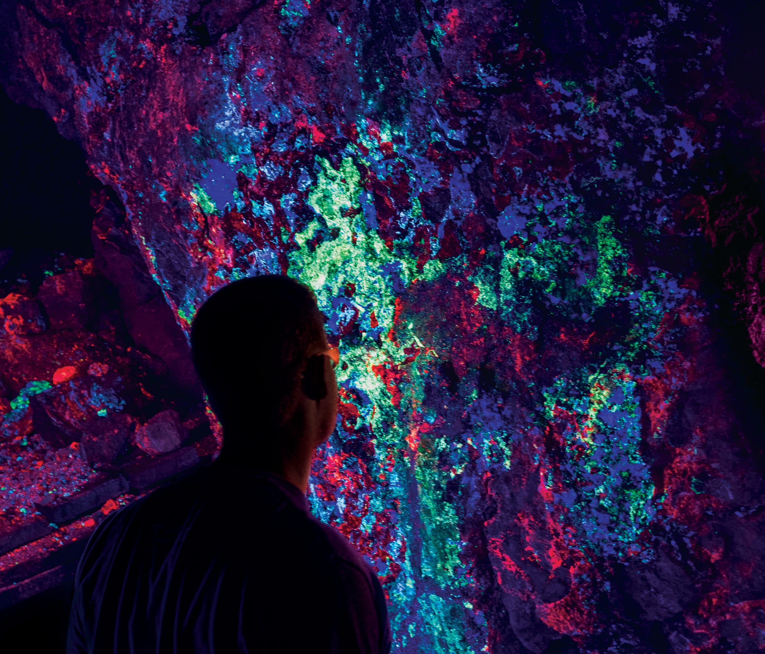 A visitor admires the display of fluorescent minerals in Hull Mine.  