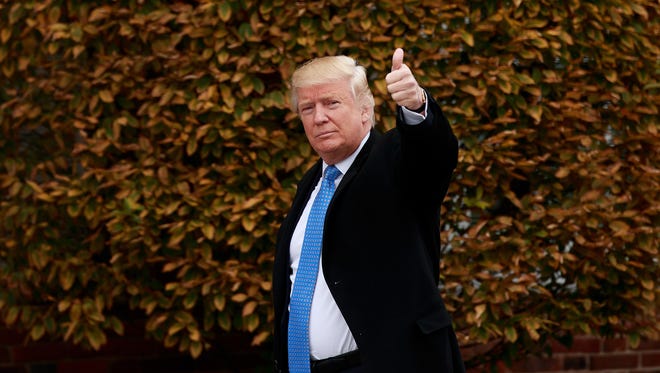 President-elect Donald Trump waves as he arrives at Trump International Golf Club for a day of meetings, Nov, 20, 2016, in Bedminster Township, New Jersey.