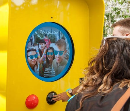 Two people watching a video on Snap's Spectacles