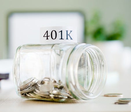 Tipped over jar with 401(k) label that is filled with coins