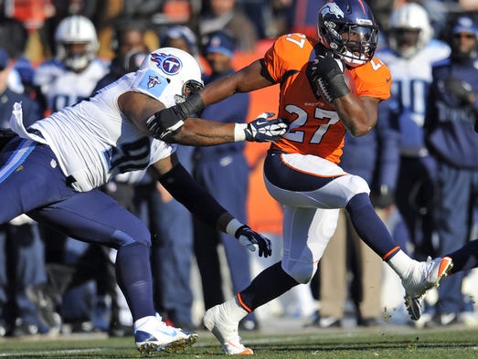 Broncos running back Knowshon Moreno pulls away from Titans defensive tackle Jurrell Casey during the first quarter on Dec. 8, 2013 at Denver.