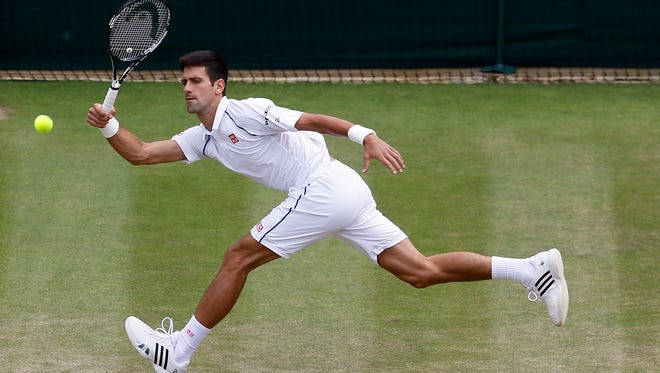 Novak Djokovic of Serbia returns a ball to  Kevin Anderson of South Africa during their singles match at the All England Lawn Tennis Championships in Wimbledon, London, Tuesday July 7, 2015.