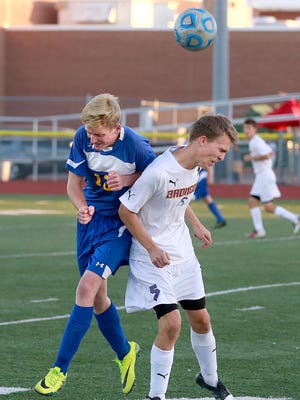 Bloomfield's Wendell Rightmire, left, and Kirtland Central's Destry Palmer fight for the ball on Tuesday at Bronco Stadium.