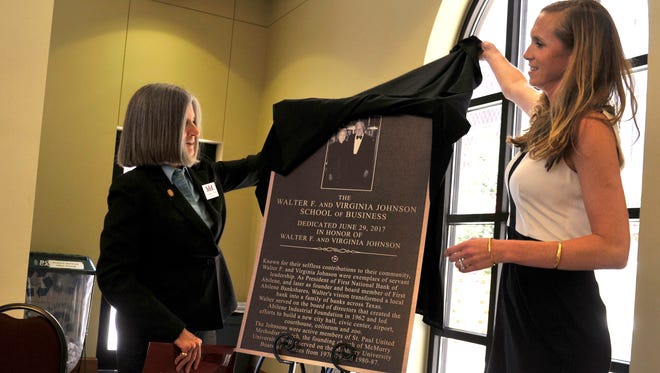 McMurry University President Sandra Harper (left) and Elizabeth Farr unveil a plaque honoring Farr's grandparents Walter and Virginia Johnson Thursday June 29, 2017. The university officially renamed the school after the Abilene banker and his wife Thursday.