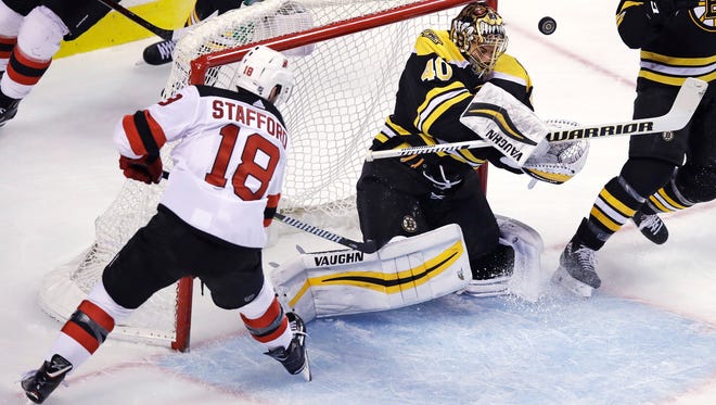 Boston Bruins goaltender Tuukka Rask (40) makes a save on a shot by New Jersey Devils right wing Drew Stafford (18) during the first period of an NHL hockey game in Boston on Tuesday, Jan. 23, 2018. (AP Photo/Charles Krupa)