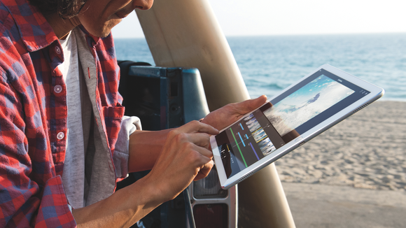 Person using iPad Pro on a beach