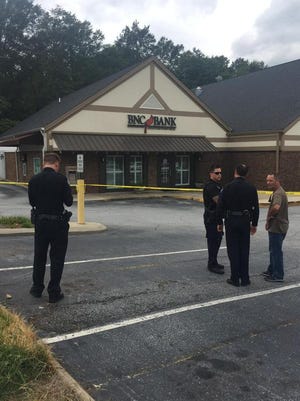 Police investigate robbery at Bank of North Carolina on Augusta Street.