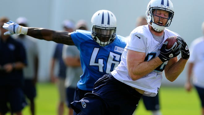 Titans tight end Taylor Thompson (84) pulls in a pass over linebacker David Gilbert (46) during practice. Thompson has had a good preseason so far.