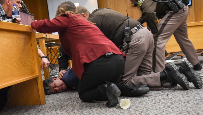 Randall Margraves, father of Lauren and Madison Margraves is detained after trying to attack Larry Nassar, Friday, Feb. 2, 2018, in Eaton County Circuit Court during the second day of victim impact statements in Judge Janice Cunningham's courtroom in Charlotte, Mich.