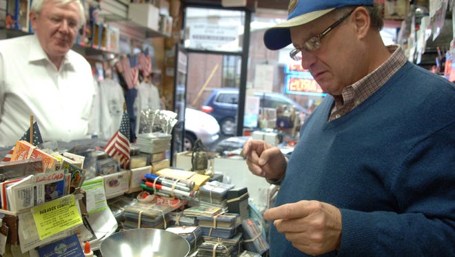 A customer has his gold weighed at Steve's Coin and Stamp Shop in Rutherford.