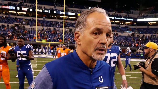 Indianapolis Colts coach Chuck Pagano runs off the field after the game with the Denver Broncos at Lucas Oil Stadium.