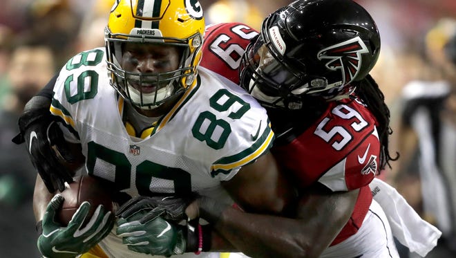 Green Bay Packers tight end Jared Cook (89) is tackled by Atlanta Falcons outside linebacker De'Vondre Campbell (59) following a fourth-quarter catch in the NFC title game.
