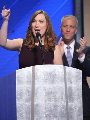 Sarah McBride becomes the first transgender person to address a major party convention during the Democratic National Convention in Philadelphia Thursday. Co-Chair of the Congressional LGBT Equality Caucus Congressman Sean Patrick Maloney applauds after introducing her.