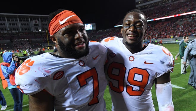 Clemson defensive lineman Austin Bryant (7), left, celebrates with defensive lineman Clelin Ferrell (99) after the Tigers 38-31 win over NC State on Saturday, Nov. 28, 2017 at Clemson's Memorial Stadium. 