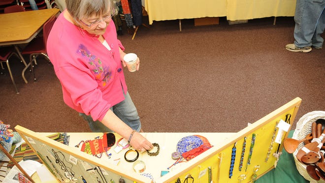 
Bev Prohl of Egg Harbor looks over a display of jewelry made from Peru, Nepal, Indonesia, Chile, Kenya and Malaysia at the Third World Marketplace last yearat Bay Lutheran Church, 11836 Wisconsin 42, Ellison Bay. Fair trade organic coffee, tea and chocolate plus creations by artisans and farmers from developing regions of the world were featured at the market. 
