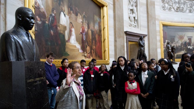 U.S. Congressional Delegate Eleanor Holmes Norton of Washington, D.C., speaks with students about Black History Month alongside a statue of Martin Luther King, Jr., during a tour of the Rotunda at the U.S Capitol on Feb. 20, 2014.