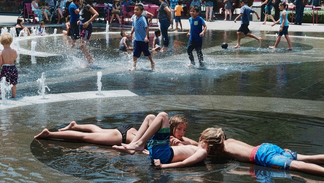 Children take advantage of the Grand Park fountain in downtown Los Angeles on Wednesday, July 5, 2017. Forecasters say a new heat wave is setting in across the West.