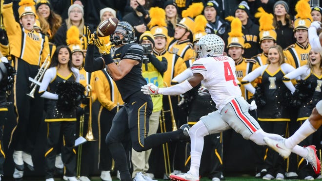 Nov 4, 2017; Iowa City, IA, USA; Iowa Hawkeyes tight end Noah Fant (87) catches a touchdown pass as Ohio State Buckeyes cornerback Jordan Fuller (4) defends during the second quarter at Kinnick Stadium. Mandatory Credit: Jeffrey Becker-USA TODAY Sports