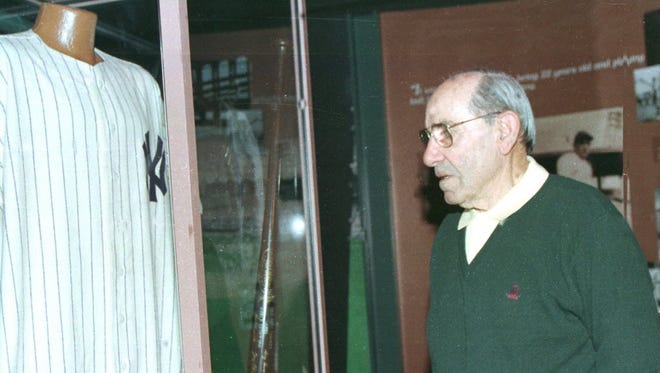 Former Yankee Yogi Berra looks over the Joe DiMaggio display at the Yogi Berra Museum on Monday March 8, 1999,located on the campus of Montclair State University where Berra talked about his friendship with DiMaggio.