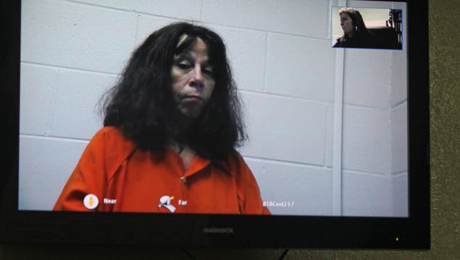 Janet Selvey, charged with murder in the death of her husband Ronnie Selvey, appears on closed-circuit TV  during a bond hearing Tuesday morning before Magistrate Denise Malone.