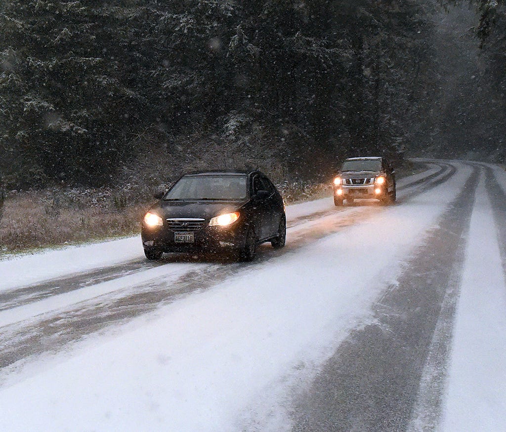 Motorists drive near Yelm, Wash., Sunday, Dec. 24, 2017. Snow, sleet and freezing rain is making holiday travel challenging in Washington state, Oregon and Idaho. Accuweather warned that more winter weather will make travel hazardous in the Pacific N
