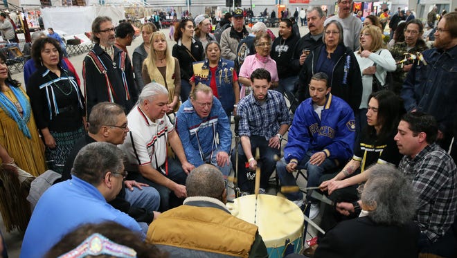Participants at the Indian Summer Winter Pow Wow join in singing "The Traveling Song," for a good trip from winter into spring, in 2015. The 2018 Winter Pow Wow is this weekend at State Fair Park.