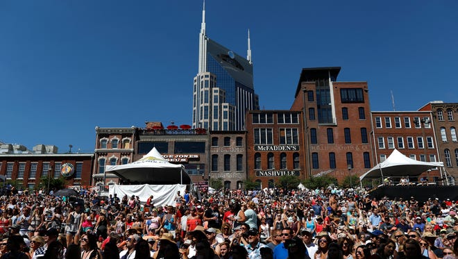 Fans listen to Tyler Farr perform Friday morning at the CMA Music Festival.