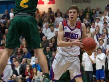 Reno's Tommy Challis looks to pass against Bishop Manogue in Saturday's Regional championship game at Carson.