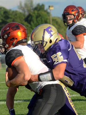 Fowlerville's Trevor Brock, right, has been unblockable in leading the Gladiator defense this fall.