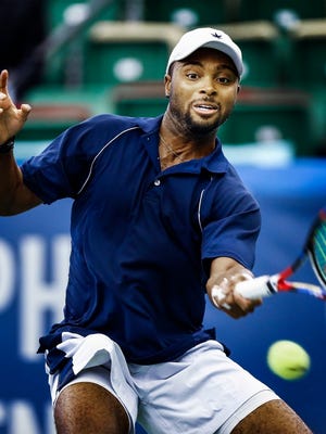 Donald Young hits a return shot during his 7-6 (7), 6-3 victory over Reilly Opelka in the second round of the Memphis Open. 