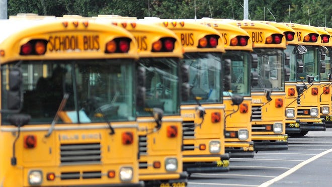 In this file photo, school buses depart the Athens-Clarke school bus depot on Monday, Nov. 16, 2015 in Athens, Ga.