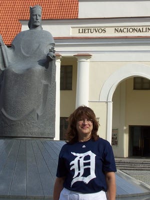 Maryann Ivers of Shelby Township, sporting the Old English D in front of King Mindaugas of Lithuania, while vacationing there with her husband in August.