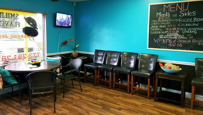 The inside of Smiling Flavors Caribbean Jerk is neat and clean with brightly colored walls and decorative tropical arrangements. There is only one table that seats four as most of their business is takeout.