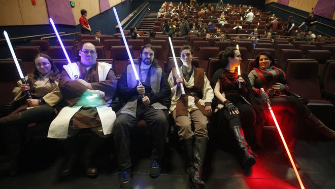 Star Wars fans dressed as Jedis are excited to see Star Wars: The Force Awakens at Harkins Tempe Marketplace on December 16, 2015.