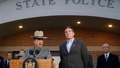 New York State Police Superintendent Joseph D'Amico, left, and Gov. Andrew Cuomo speak to members of the media during a news conference, Friday, June 26, 2015, in Malone, N.Y. Richard Matt, one of two convicted murderers who staged an escape from an upstate maximum-security prison three weeks ago was shot and killed by a Border Patrol agent in a wooded area about 30 miles from the prison on Friday, while David Sweat remains on the run. (AP Photo/Mary Altaffer)