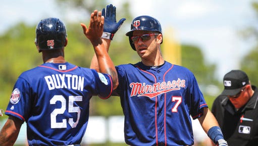 Minnesota Twins' Byron Buxton (25) high-fives Joe Mauer after his two run home run in the fourth inning against the Tampa Bay Rays during a spring training baseball game at Charlotte Sports Park in Port Charlotte, Fla., Thursday, March 30.