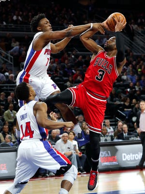 Pistons forward Stanley Johnson fouls Bulls guard Dwyane Wade as Ish Smith looks on in the first half Tuesday, Dec. 6, 2016 at the Palace.