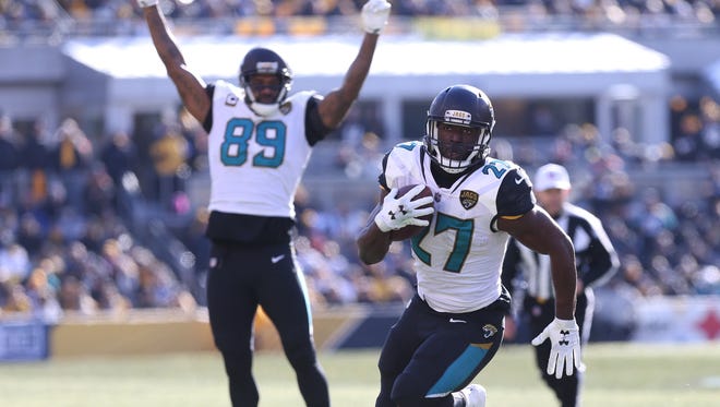 Jacksonville Jaguars running back Leonard Fournette (27) carries the ball to score a touchdown in front of Jaguars tight end Marcedes Lewis (89) against the Pittsburgh Steelers during the first quarter in the AFC Divisional Playoff game at Heinz Field.