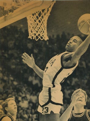 Iowa's Roy Marble grabs a rebound above Michigan's Garde Thompson and Mike Griffin.