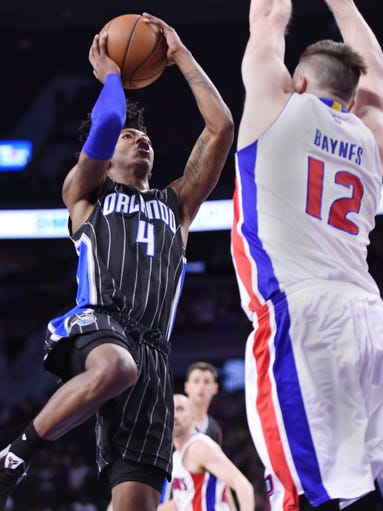 Pistons' Aron Baynes blocks the path of Magic's Elfrid