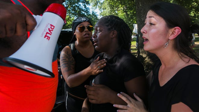 Antonio Blair, left, and Mahal Burr, right, console Sydney Kesler, middle, after her friend, Patrick Ghant, was arrested by Memphis police officers Saturday, Aug. 19, 2017, at an event that started out as a peaceful protest at Nathan Bedford Forrest's Confederate statue, but turned chaotic during #TakeEmDown901's "Rally for Removal! Solidarity with Charlottesville!" action at Health Sciences Park. The event followed a weeklong effort to have Confederate monuments, like Forrest and Jefferson Davis, removed from the city.