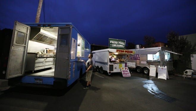 Peter Clarke orders from JT's Food Truck in the pod behind Barrel & Keg Friday, Oct. 9, 2015, near downtown Salem.           